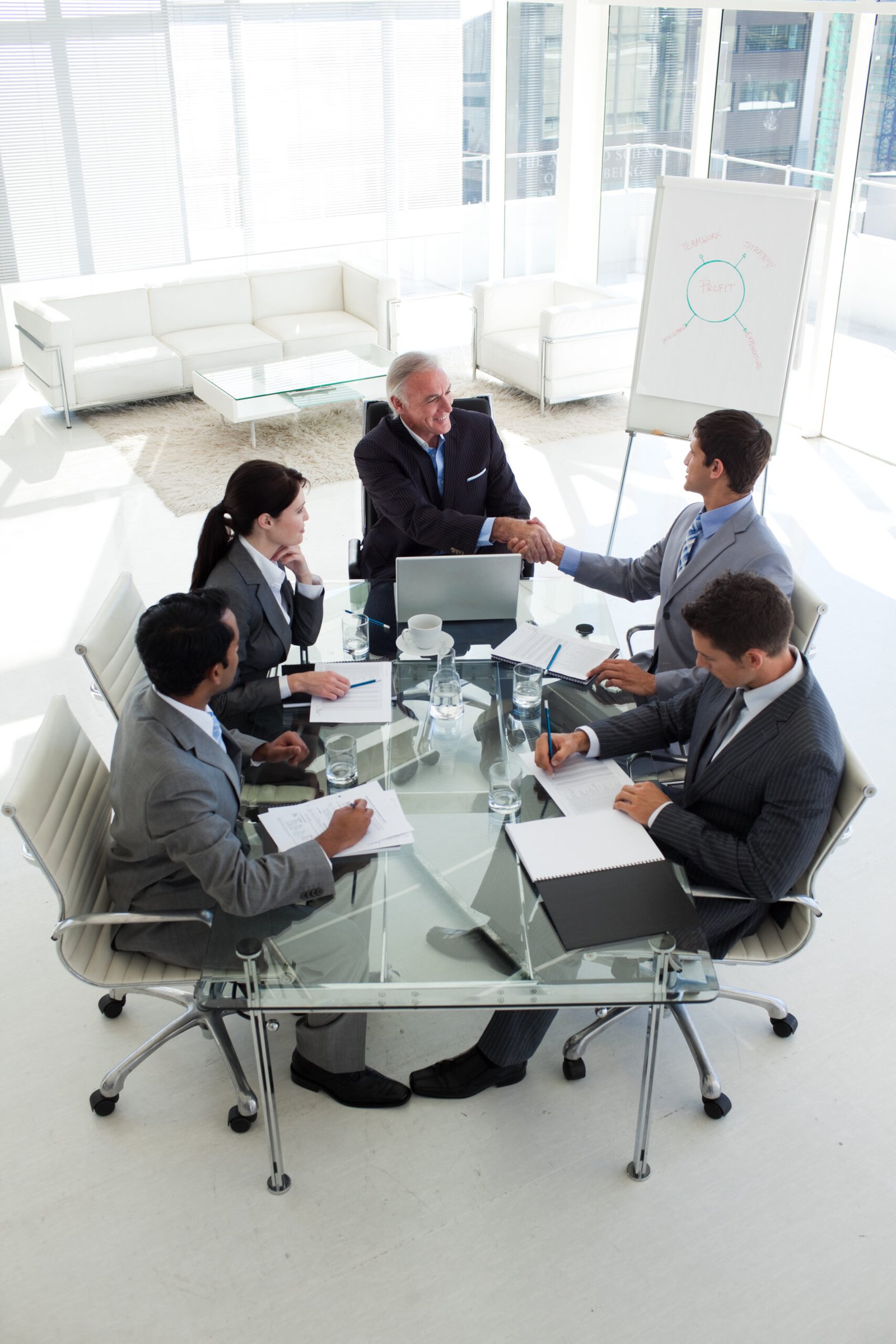 Senior manager and businessman shaking hand at the end of a meeting